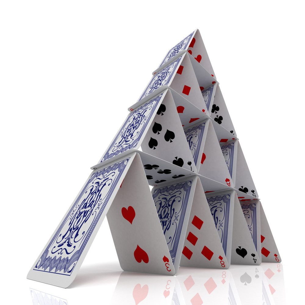House of cards over a glossy white surface