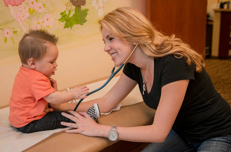 pediatric nurse practitioner examining baby